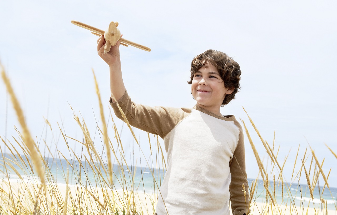 Child with Air-plane on Beach | Alpha Airport Parking