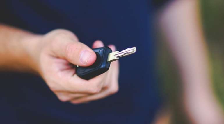 Man holding a car key | Alpha Airport Parking