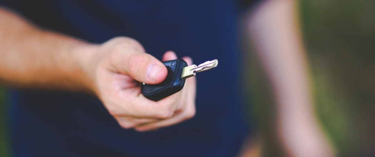 Man holding a car key | Alpha Airport Parking